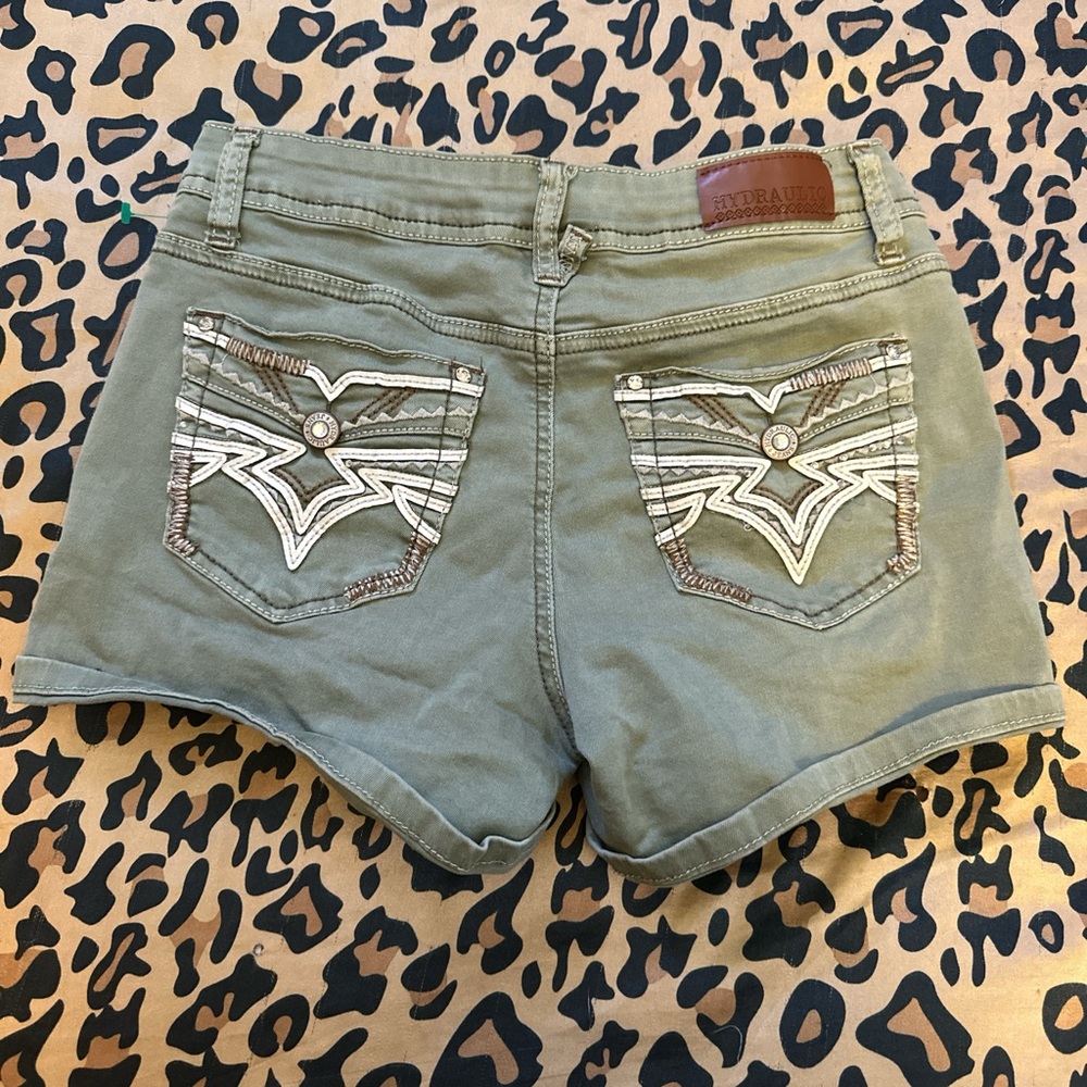 green shorts with white and studded detailing
